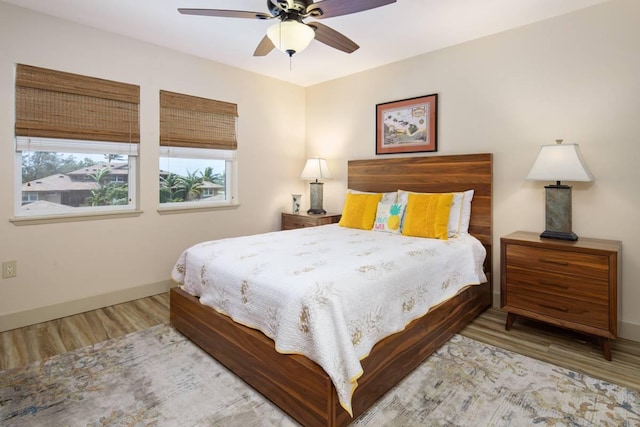 bedroom featuring hardwood / wood-style floors and ceiling fan