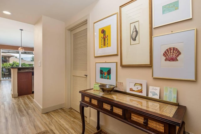 hall with light hardwood / wood-style flooring