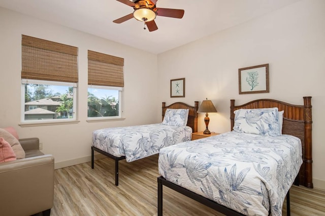 bedroom with ceiling fan and light hardwood / wood-style flooring