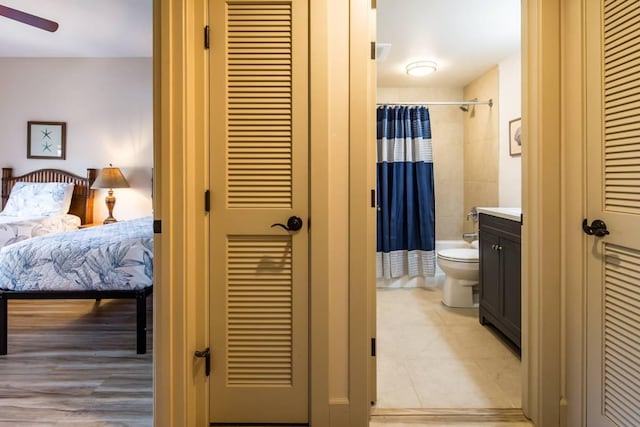 bedroom featuring connected bathroom and light tile patterned flooring