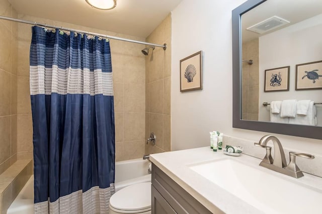 full bathroom with vanity, shower / tub combo with curtain, and toilet