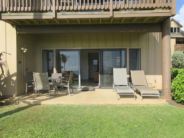 back of property featuring a lawn and a patio area