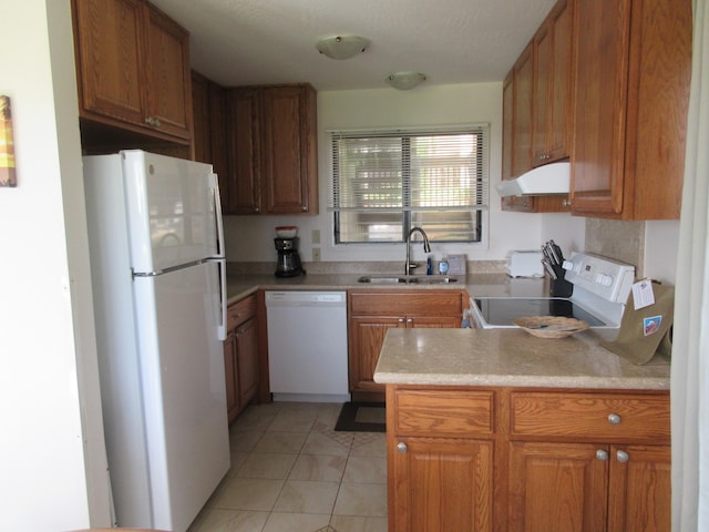 kitchen with sink, light tile patterned floors, white appliances, and kitchen peninsula