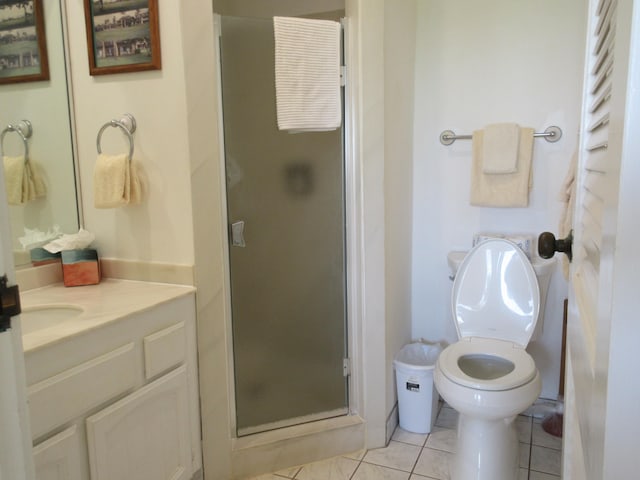 bathroom featuring vanity, tile patterned floors, toilet, and walk in shower