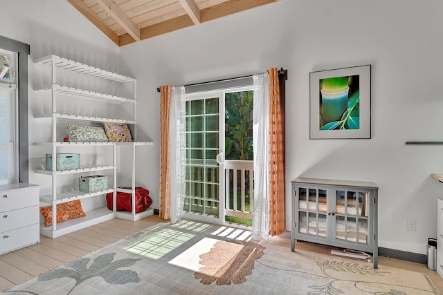 interior space featuring lofted ceiling with beams, wood ceiling, and light wood-type flooring