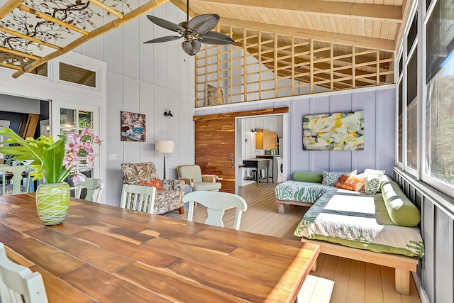 sunroom featuring lofted ceiling with beams and ceiling fan