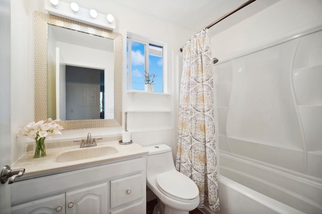 bathroom featuring toilet, shower / bath combo with shower curtain, and vanity