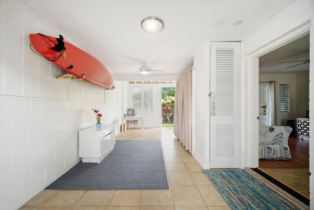 hall with light tile patterned floors