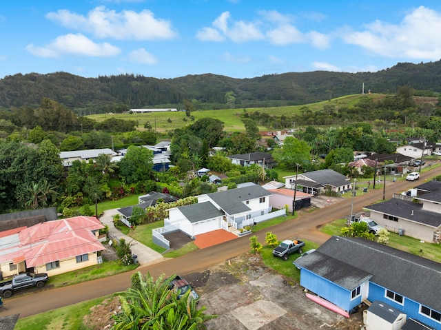 aerial view with a wooded view, a mountain view, and a residential view