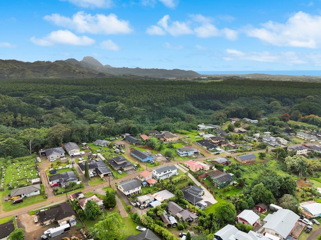 bird's eye view featuring a residential view, a mountain view, and a wooded view