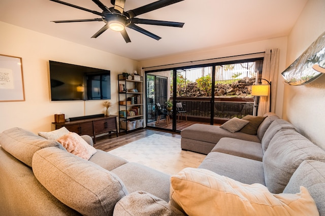 living area with a ceiling fan and wood finished floors