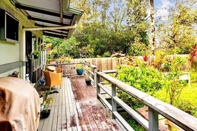 wooden terrace featuring a fenced backyard