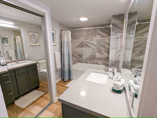 full bathroom with toilet, shower / bathtub combination with curtain, wood-type flooring, and vanity