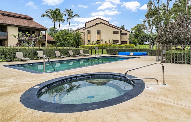 view of pool with a patio and a community hot tub