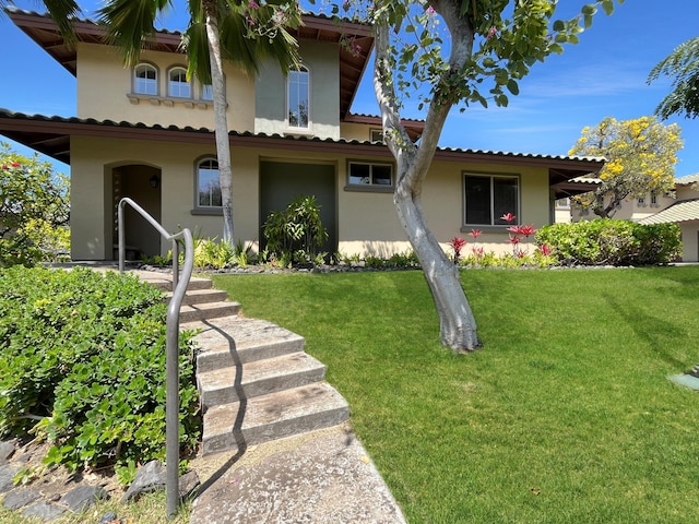 view of front facade with a front lawn and stucco siding