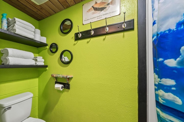 bathroom with wooden ceiling and toilet