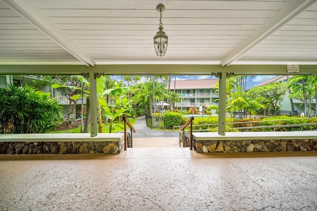 unfurnished sunroom with beam ceiling