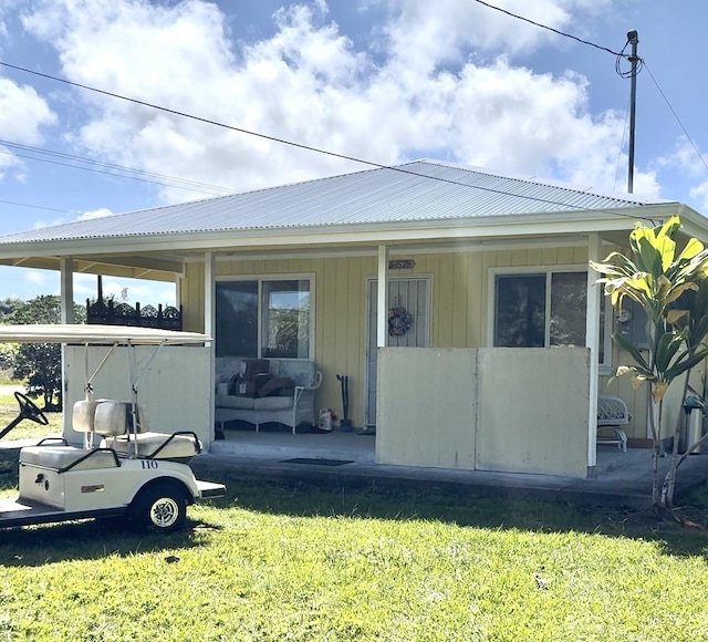 exterior space featuring a porch and a lawn