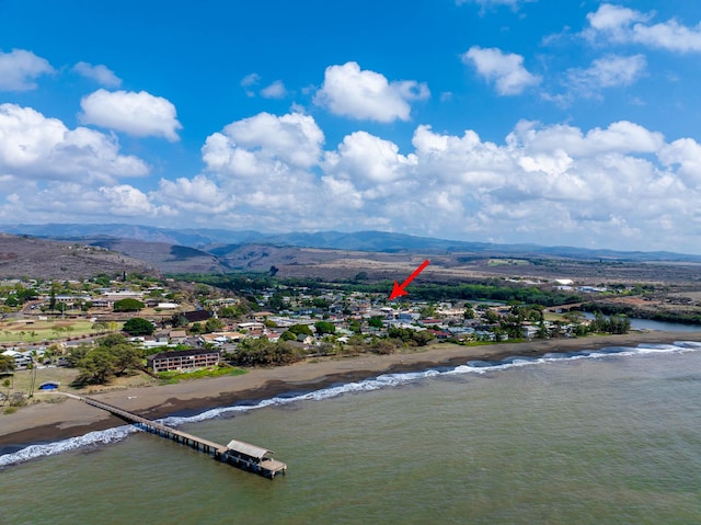 birds eye view of property featuring a beach view and a water and mountain view