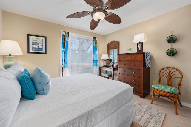 bedroom featuring ceiling fan, baseboards, and light carpet