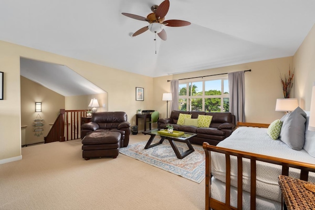 carpeted living room featuring baseboards, lofted ceiling, and ceiling fan