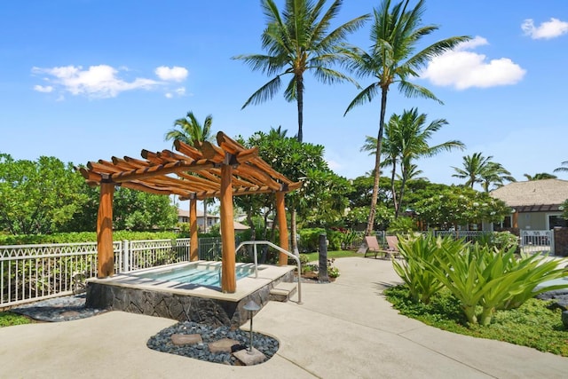 view of patio featuring fence, an in ground hot tub, and a pergola