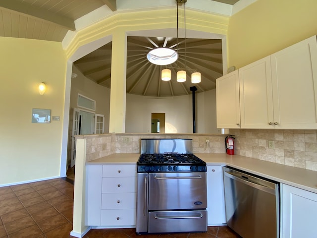 kitchen featuring white cabinetry, appliances with stainless steel finishes, dark tile patterned floors, beam ceiling, and decorative backsplash