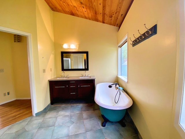 bathroom with a washtub, tile patterned flooring, vanity, vaulted ceiling, and wooden ceiling