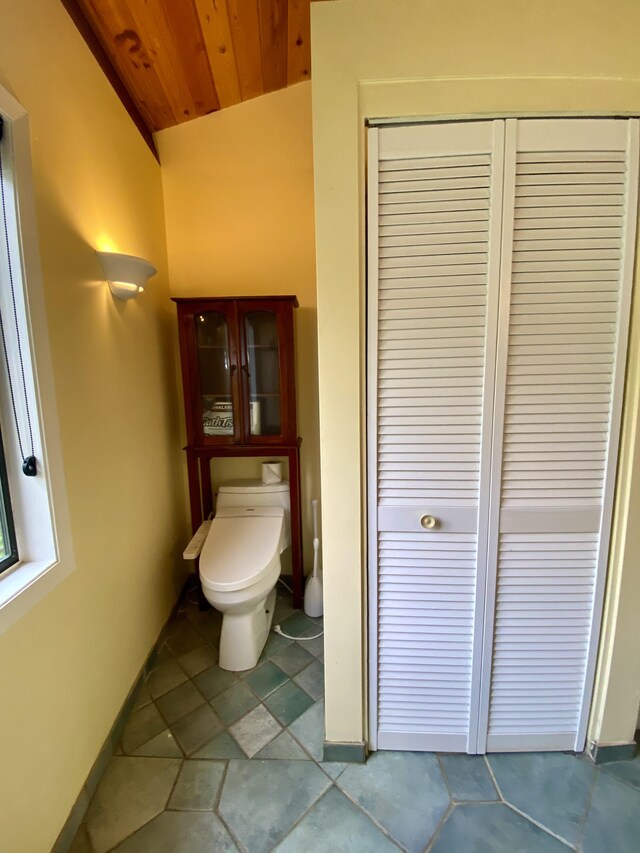 bathroom featuring vaulted ceiling, wooden ceiling, and toilet