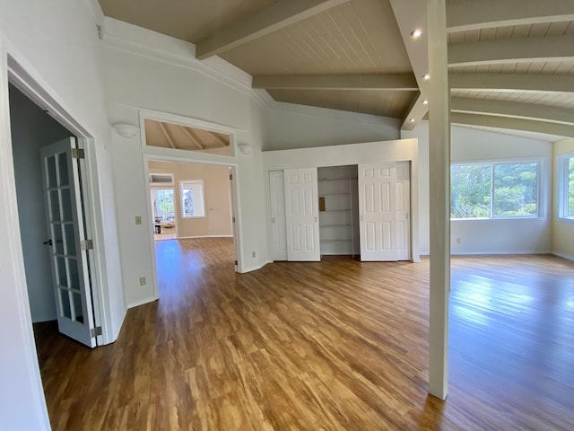 unfurnished room with hardwood / wood-style floors, wood ceiling, and lofted ceiling with beams