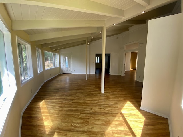 spare room with lofted ceiling with beams and wood-type flooring