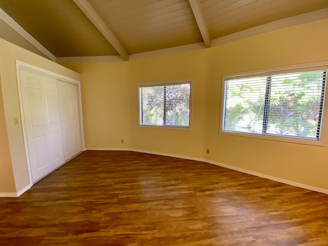 unfurnished bedroom with vaulted ceiling with beams, dark hardwood / wood-style flooring, and a closet