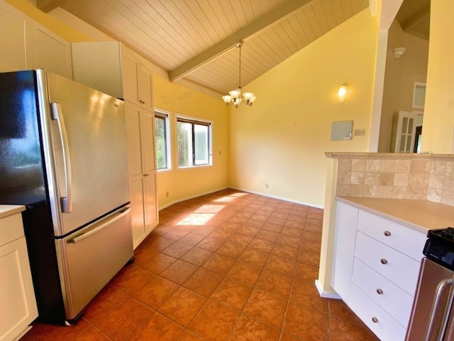 kitchen with white cabinetry, lofted ceiling with beams, an inviting chandelier, and appliances with stainless steel finishes