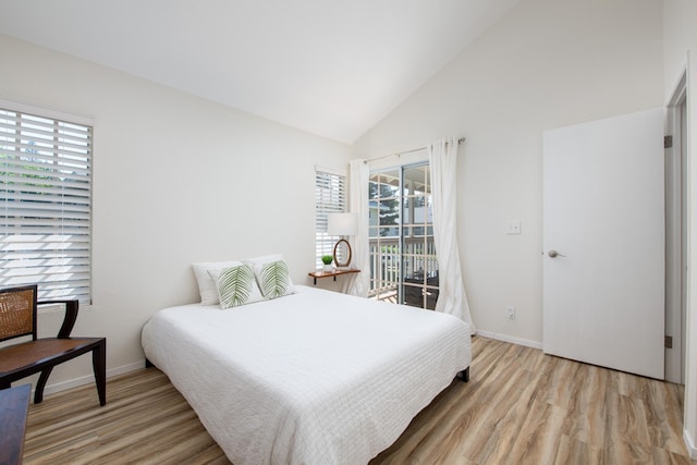 bedroom with baseboards, high vaulted ceiling, light wood-style flooring, and access to exterior