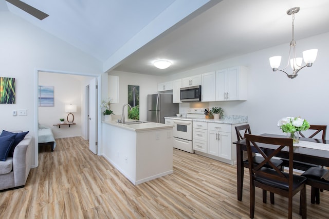 kitchen with white cabinets, a sink, stainless steel appliances, and light countertops