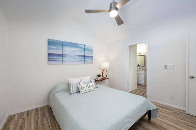 bedroom with lofted ceiling, baseboards, and wood finished floors