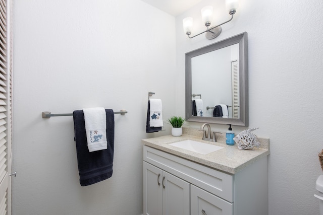 bathroom with a closet and vanity