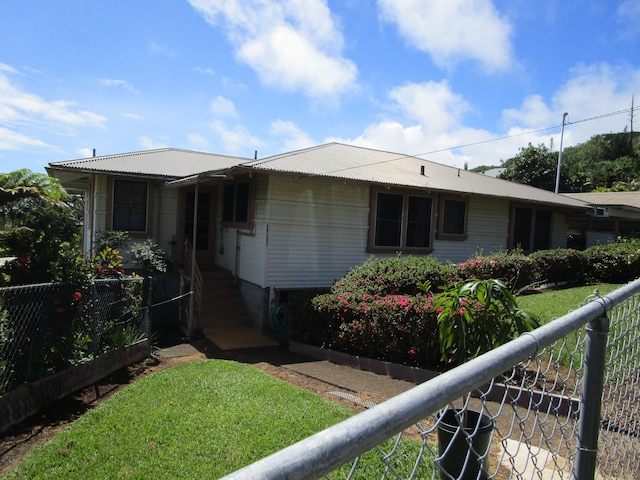 view of front of home featuring a front lawn and fence private yard