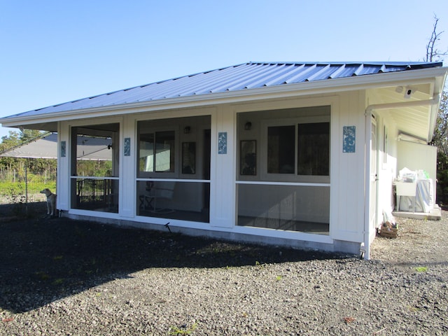 rear view of property with a sunroom