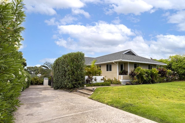 view of front of house with a front lawn and roof with shingles