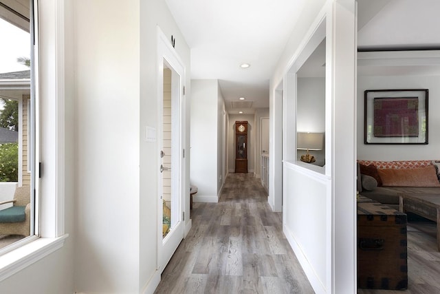 corridor with attic access, recessed lighting, baseboards, and light wood finished floors