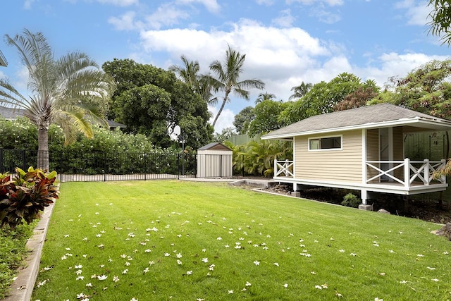 view of yard with an outbuilding, a shed, and fence