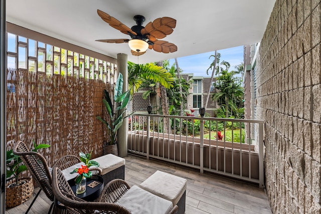 wooden terrace with ceiling fan and covered porch