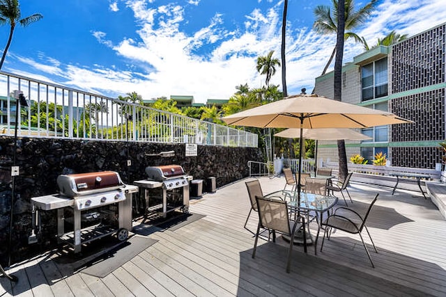 deck featuring grilling area and fence