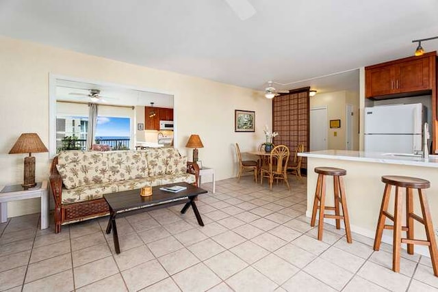 living room with light tile patterned floors and a ceiling fan