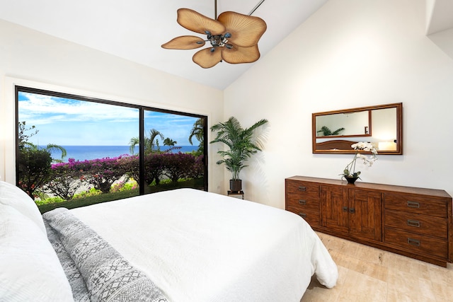 bedroom with a ceiling fan, a water view, vaulted ceiling, and light wood finished floors