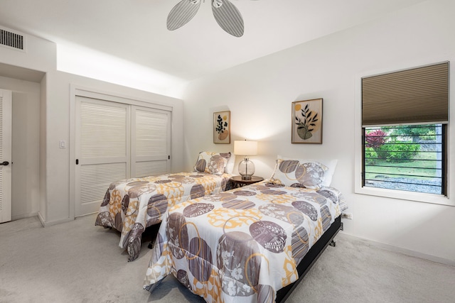 bedroom featuring a closet, visible vents, a ceiling fan, carpet flooring, and baseboards