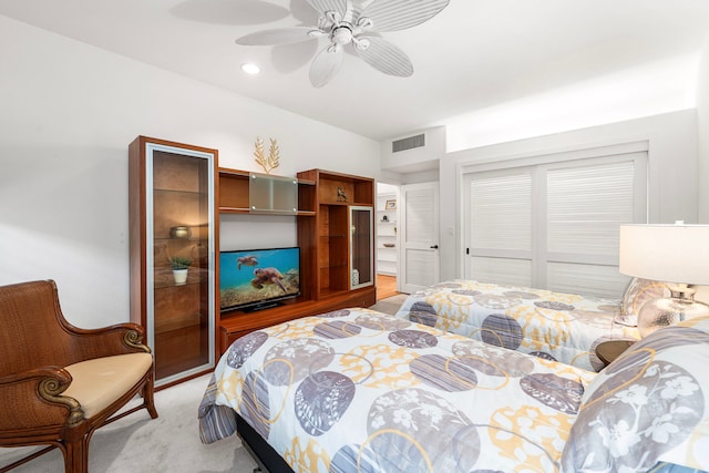 bedroom with light carpet, visible vents, a ceiling fan, a closet, and recessed lighting