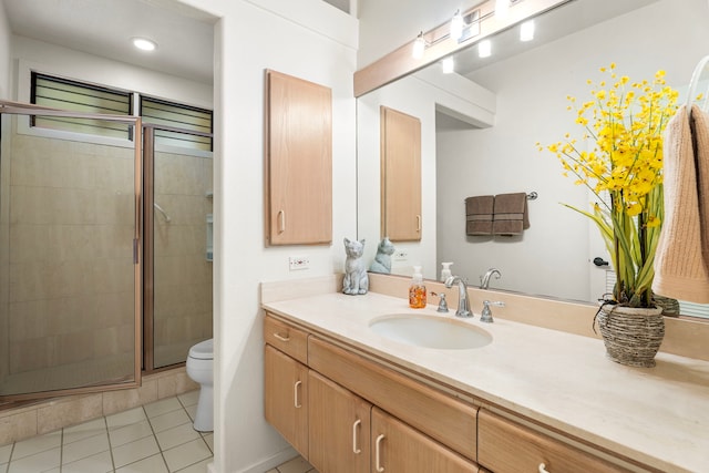 bathroom with toilet, tile patterned floors, a shower stall, and vanity