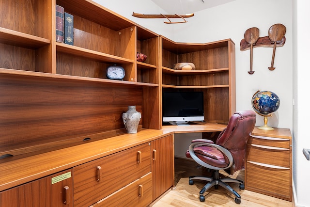 office space with light wood-style floors and built in study area